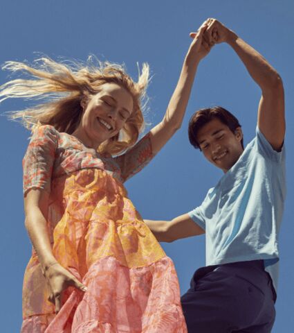 Couple dancing together outside.