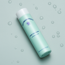 nu-skin-nutricentials-here-you-glow-exfoliating-toner-water-drops-aerial-lifestyle-image