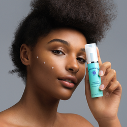 A woman applying Nu Skin Nutricentials Celltrex Always Right Recovery Fluid to her face