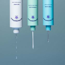 Three Nutricentials products hanging upsidedown dripping their respective gels and lotions.