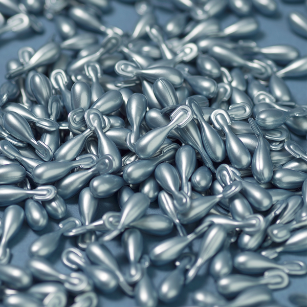 Large pile of ageLOC Tru Face Essence Ultra capsules scattered around.