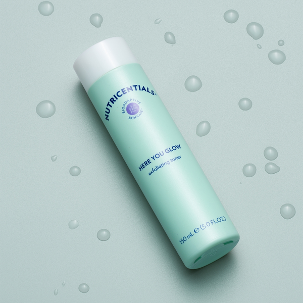 nu-skin-nutricentials-here-you-glow-exfoliating-toner-water-drops-aerial-lifestyle-image